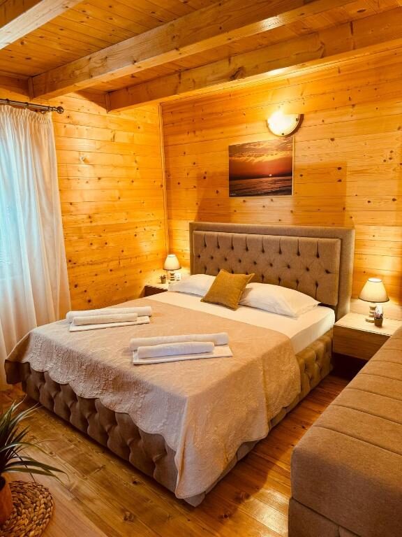 Bedroom with upholstered headboard and warm wooden interior