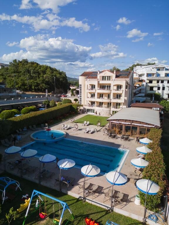 Hotel building with pool, playground and sun terrace